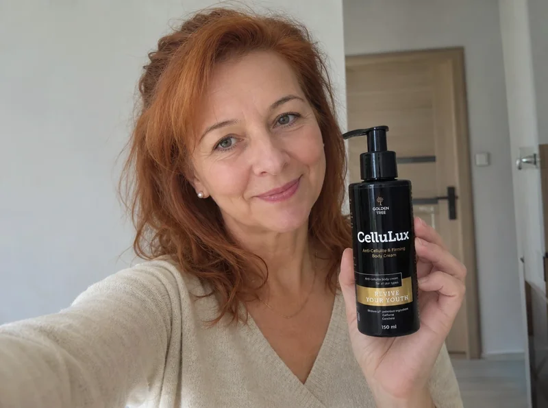 Woman with copper hair holding CelluLux product