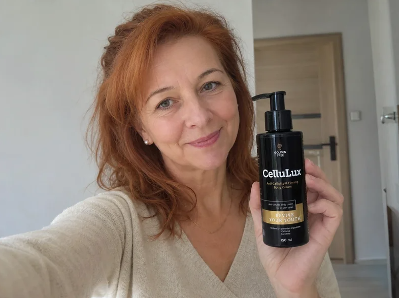 Woman with copper hair holding CelluLux product