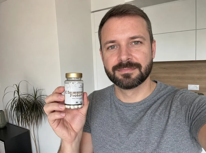 Man holding C ImmunoProtect bottle at home