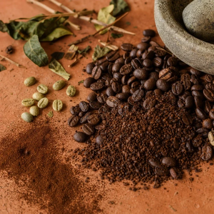 Coffee beans and ground caffeine on terracotta
