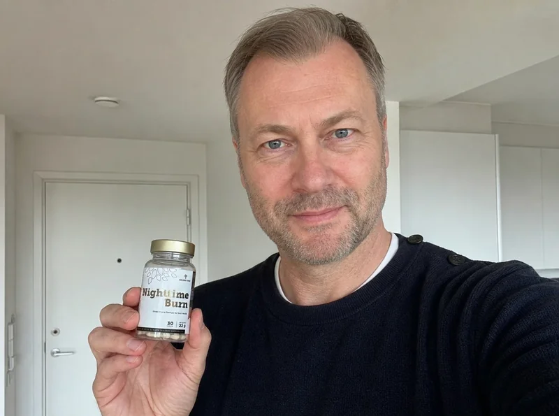 Man at home holding Nighttime Burn product