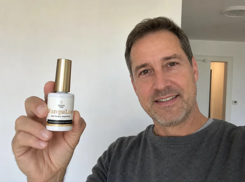 Man 45 holding FunguLux bottle indoors