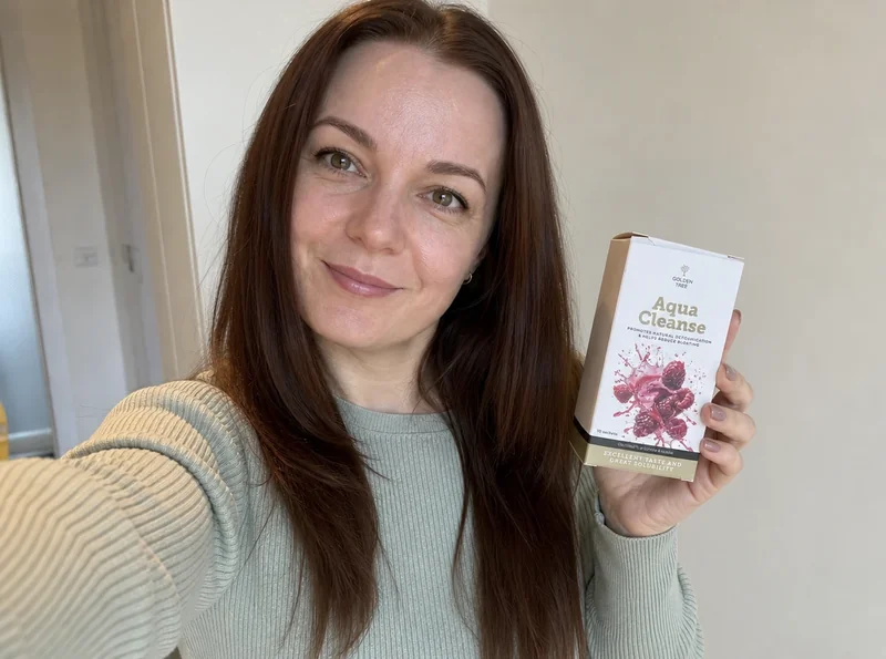 Woman holding Golden Tree Aqua Cleanse selfie