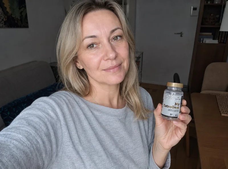 Woman holding EstroGem bottle in selfie