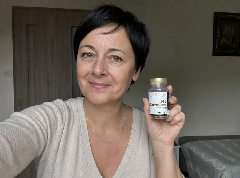 Woman with pixie cut holding supplement bottle