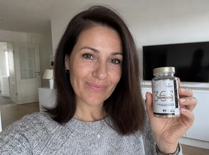 Woman holding supplement bottle at home