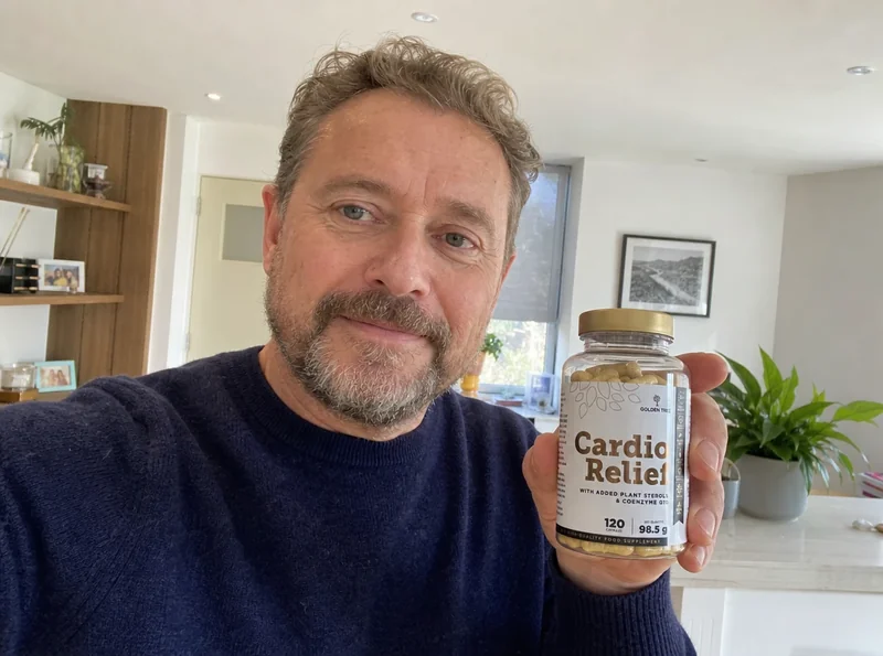Man holding supplement bottle at home